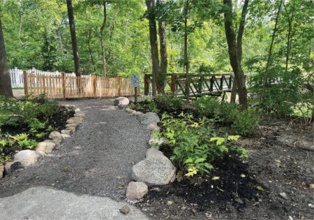 Naturalized pathways constructed of decomposed granite and mixed size boulders.